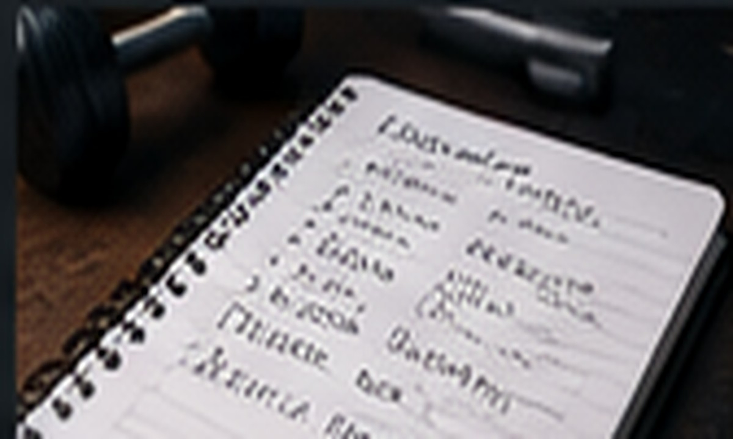 A training log beside workout equipment